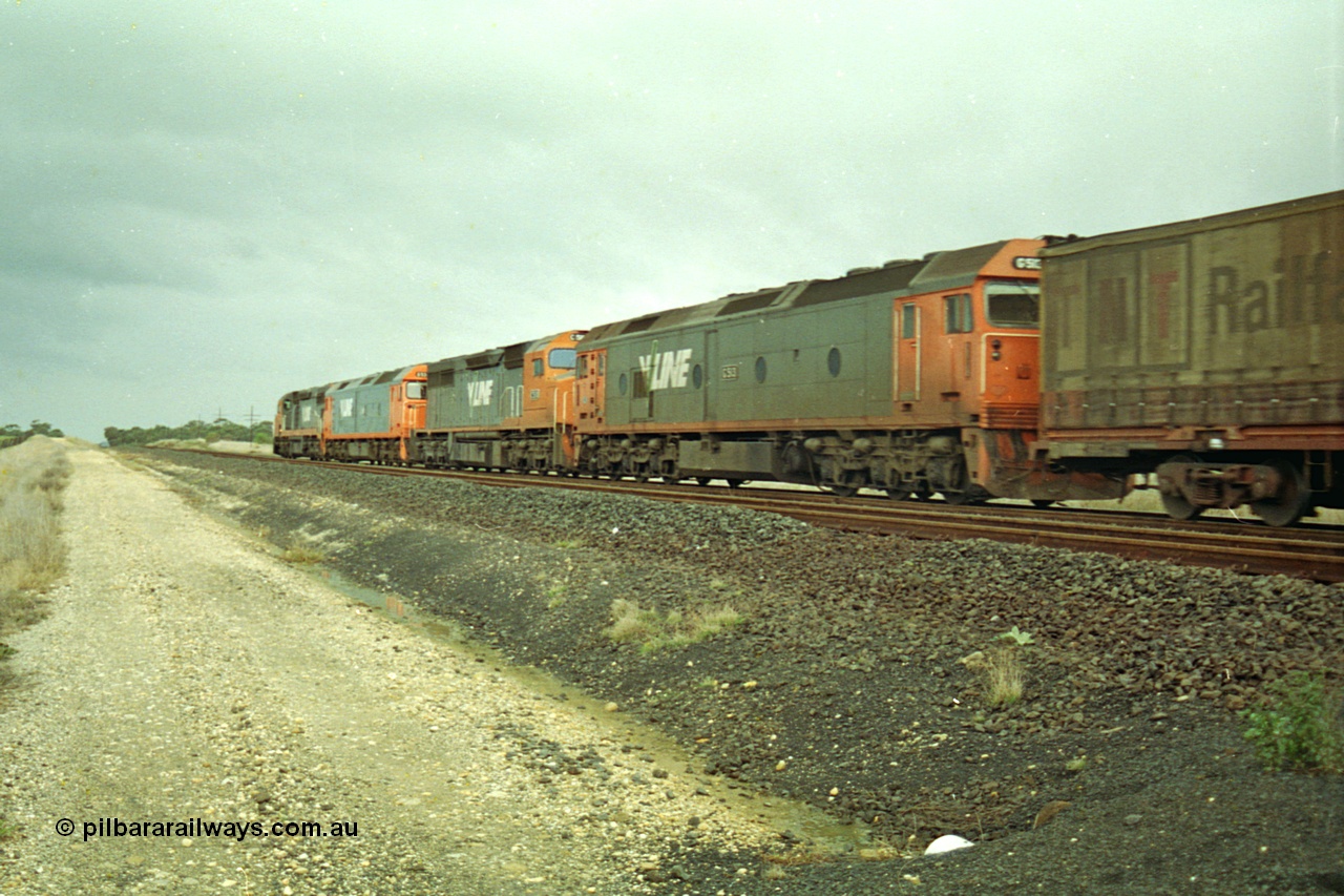 113-20
Parwan Loop, V/Line broad gauge up Adelaide goods train 9150 behind the quad CGCG combo of C class C 506 Clyde Engineering EMD model GT26C serial 76-829, G class G 538 Clyde Engineering EMD model JT26C-2SS serial 89-1271, C 510 serial 76-833 and G 513 serial 85-1241, in miserable conditions, poor quality, trailing shot.
