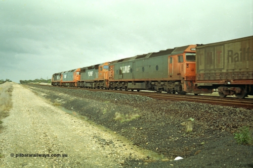 113-20
Parwan Loop, V/Line broad gauge up Adelaide goods train 9150 behind the quad CGCG combo of C class C 506 Clyde Engineering EMD model GT26C serial 76-829, G class G 538 Clyde Engineering EMD model JT26C-2SS serial 89-1271, C 510 serial 76-833 and G 513 serial 85-1241, in miserable conditions, poor quality, trailing shot.
