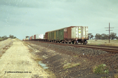 113-22
Parwan Loop, V/Line broad gauge train 9150, up Adelaide goods, in miserable conditions, poor quality, trailing shot.
