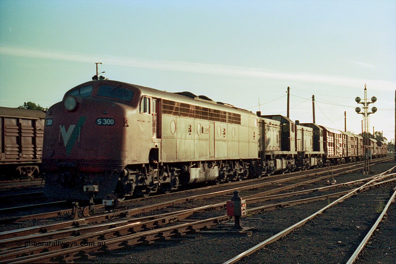 114-28
Benalla yard broad gauge V/Line S class leader S 300 'Matthew Flinders' Clyde Engineering EMD model A7 serial 57-164 and T classes T 404 Clyde Engineering EMD model G18B serial 67-499 and T 376 Clyde Engineering EMD model G8B serial 64-331 on No. 5 Road with a stabled down Wodonga goods train 9303, Benalla yard is still signalled and interlocked as witnessed by the ground and post disc signals.
Keywords: S-class;S300;Clyde-Engineering-Granville-NSW;EMD;A7;57-164;bulldog;T-class;T404;G18B;67-499;T376;G8B;64-331;