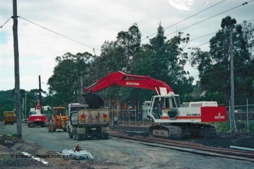 115-04
Hurstbridge, view of stabling yard being upgraded, Sumitomo excavator, new fencing and timber traction poles, old soil being removed.
