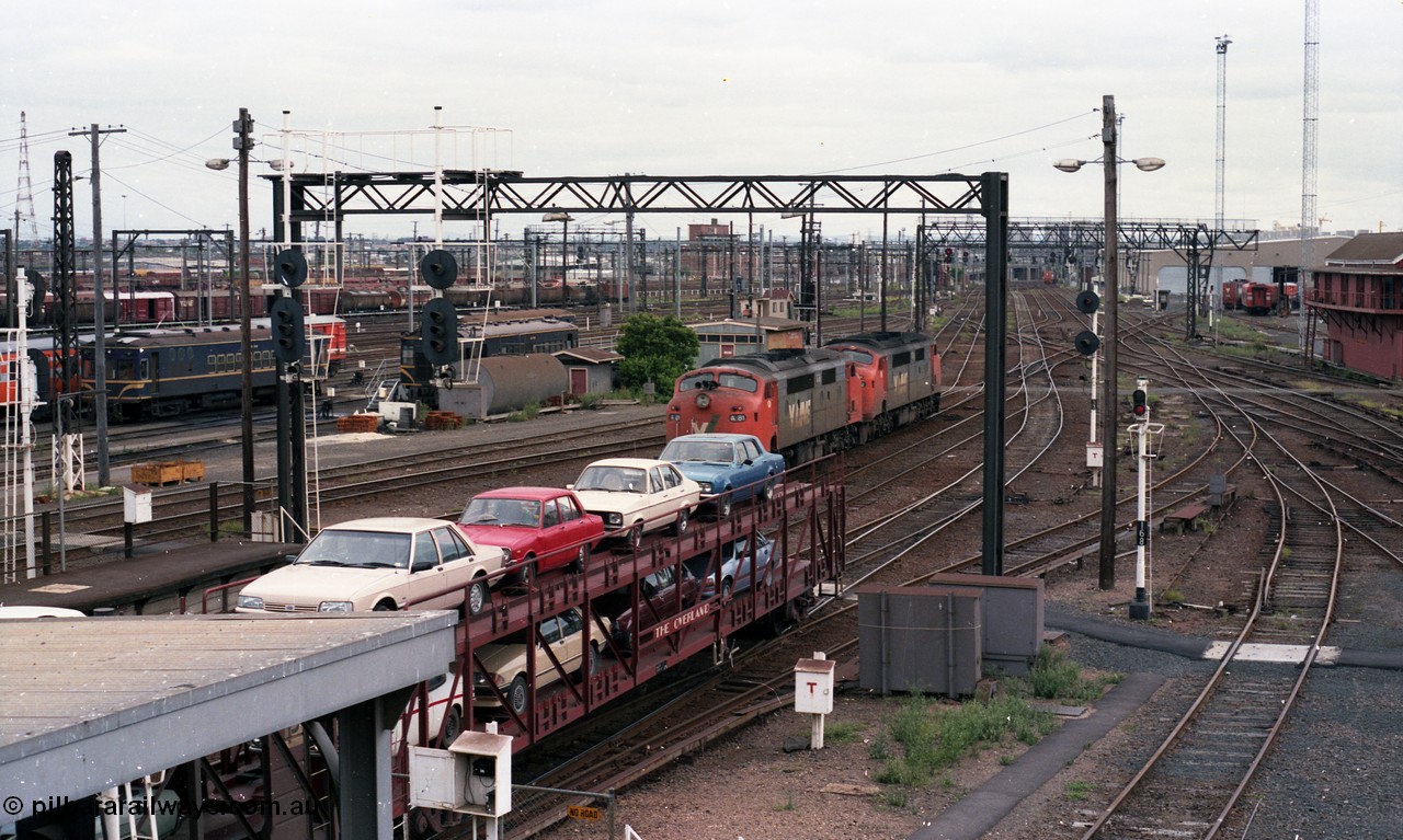 116-07
Spencer Street Station, view looking south from flyover, V/Line broad gauge A class A 62 runs light engine, in the background is a 'Tea Cup' V/Line liveried N set couple to current V/Line liveried N set, in the background are stored Y and T class locomotives.
