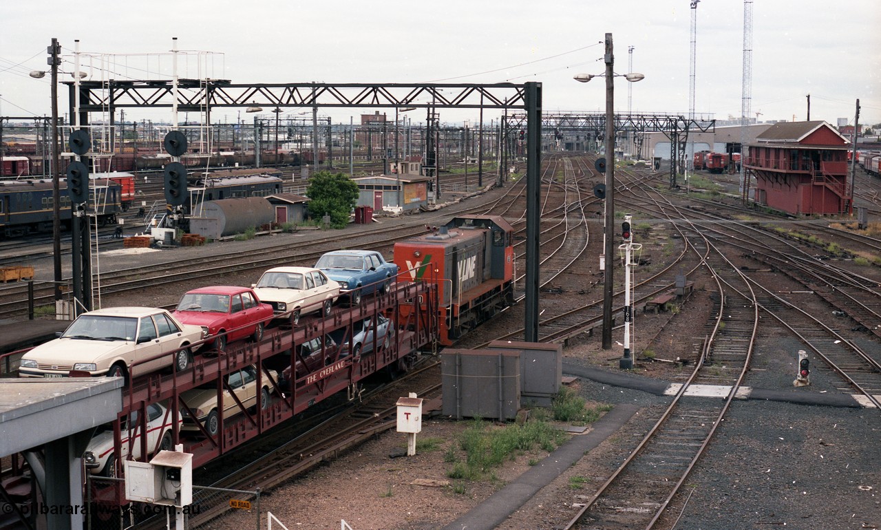 116-10
Spencer Street Station, view looking west from flyover, V/Line broad gauge Y class pilot Y 151 Clyde Engineering EMD model G6B serial 67-571 runs towards platform No.2 to collect the 'The Overland' Motorail waggons, DERMs 55 RM and 54 RM at left, West Tower in the middle background, Spencer Street No.1 Signal Box at right with broad gauge passenger stabling and maintenance sidings behind it, track work, points, searchlight signals and gantries and shunting signals.
Keywords: Y-class;Y151;67-571;Clyde-Engineering-Granville-NSW;EMD;G6B;