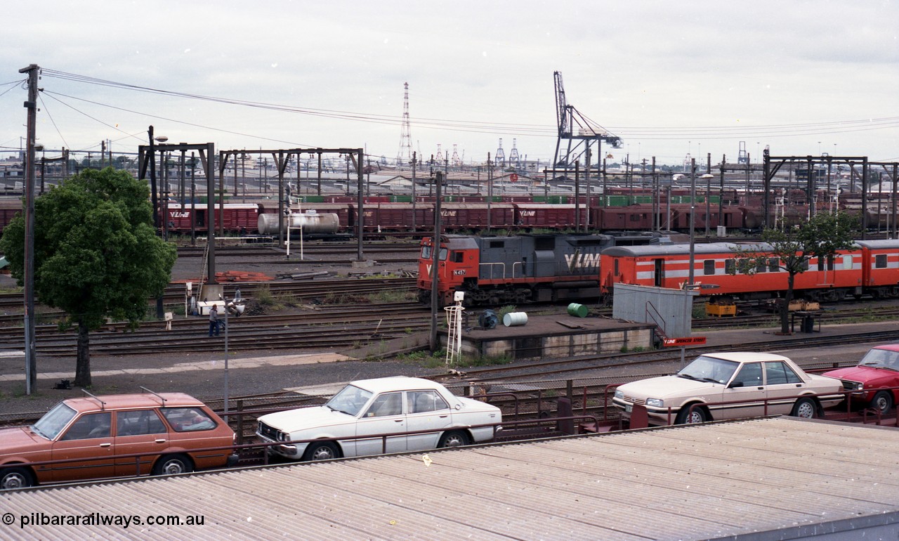 116-13
Spencer Street Station, view from flyover looking south, V/Line broad gauge N class N 457 'City of Mildura' Clyde Engineering EMD model JT22HC-2 serial 85-1225 shunts past stabled 'Tea Cup' liveried V/Line H set SH 29, view across Melbourne Goods Yard with Port of Melbourne in the distance, Motorail waggons on 'The Overland' in the foreground.
Keywords: N-class;N457;Clyde-Engineering-Somerton-Victoria;EMD;JT22HC-2;85-1225;