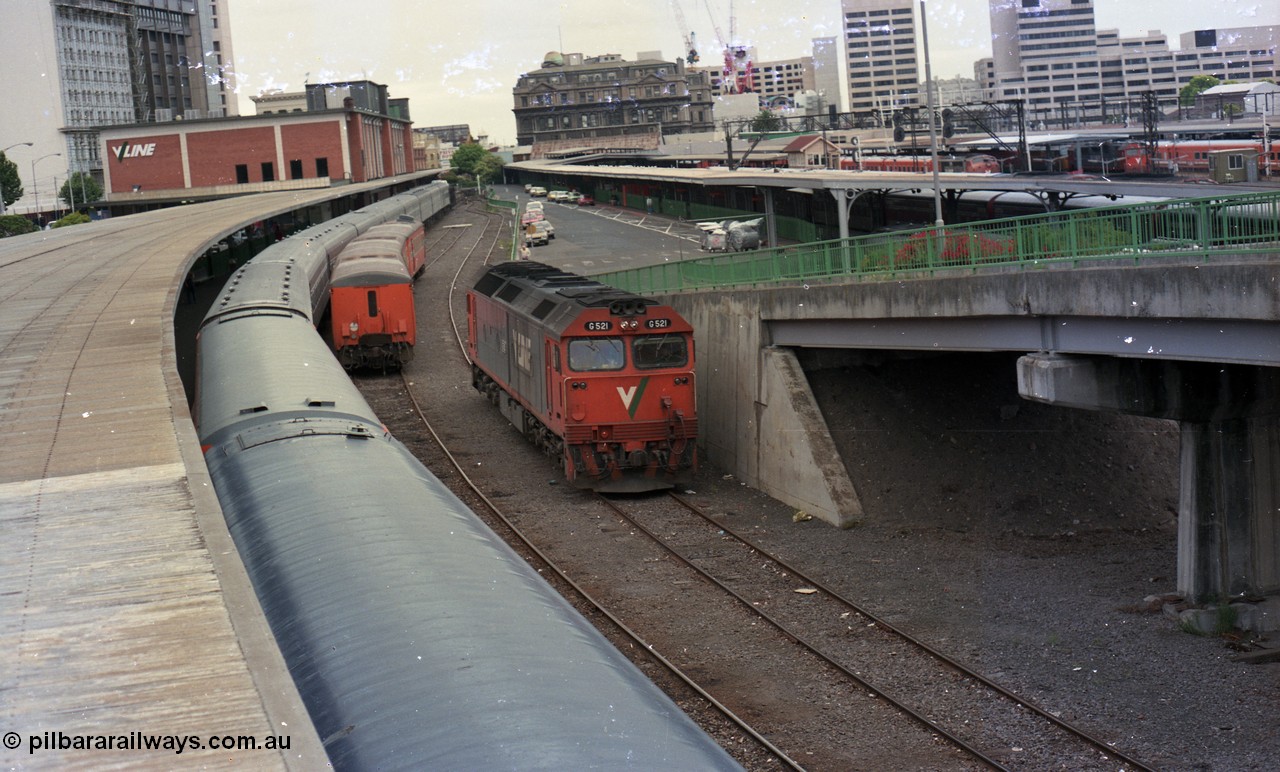 116-14
Spencer Street Station, view from flyover looking north, dual gauge Platform No.1 with Melbourne Express carriage set, a stabled V/Line broad gauge H set in the East Passenger Yard siding and standard gauge V/Line G class G 521 Clyde Engineering EMD model JT26C-2SS serial 85-1234 runs light engine to South Dynon having cut off from the Melbourne Express.
Keywords: G-class;G521;Clyde-Engineering-Rosewater-SA;EMD;JT26C-2SS;85-1234;