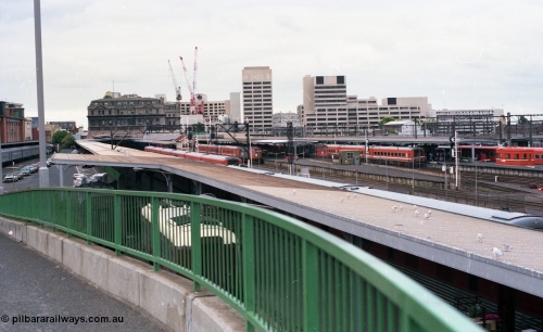 116-05
Spencer Street Station, view looking east from flyover, platform No.2 below with standard gauge car dock, South End Signal Box visible on Platform No's 3 and 4, V/Line N sets, A and N class locos, Crown Casino in the background behind the Spencer Street V/Line head office building, platform No.1 at far left.
