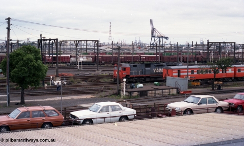 116-13
Spencer Street Station, view from flyover looking south, V/Line broad gauge N class N 457 'City of Mildura' Clyde Engineering EMD model JT22HC-2 serial 85-1225 shunts past stabled 'Tea Cup' liveried V/Line H set SH 29, view across Melbourne Goods Yard with Port of Melbourne in the distance, Motorail waggons on 'The Overland' in the foreground.
Keywords: N-class;N457;Clyde-Engineering-Somerton-Victoria;EMD;JT22HC-2;85-1225;