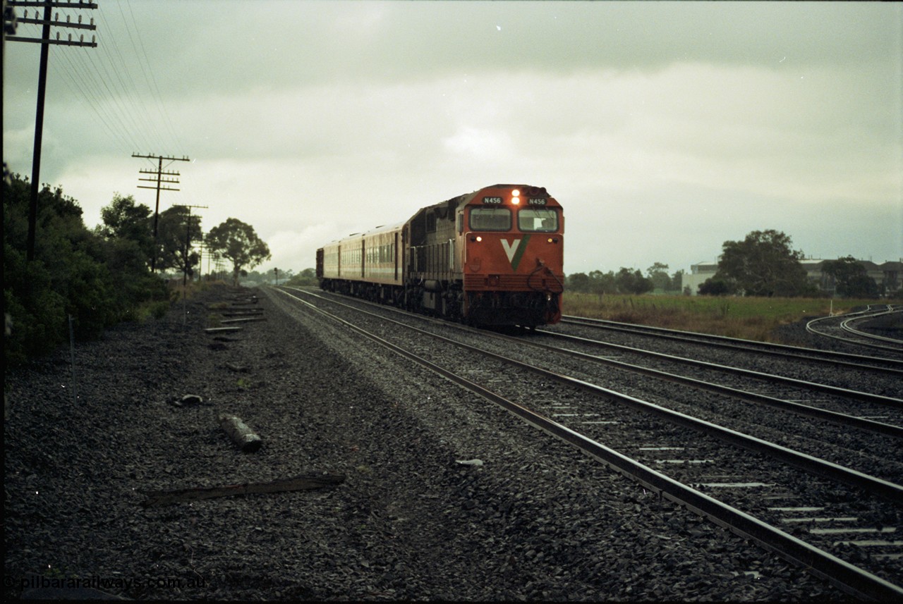 117-02
Somerton, V/Line N class loco N 456 'City of Colac' with serial 85-1224 a Clyde Engineering Somerton Victoria built EMD model JT22HC-2 with up Albury passenger train, standard gauge line on far right, with dual gauge sidings, in driving rain.
Keywords: N-class;N456;Clyde-Engineering-Somerton-Victoria;EMD;JT22HC-2;85-1224;