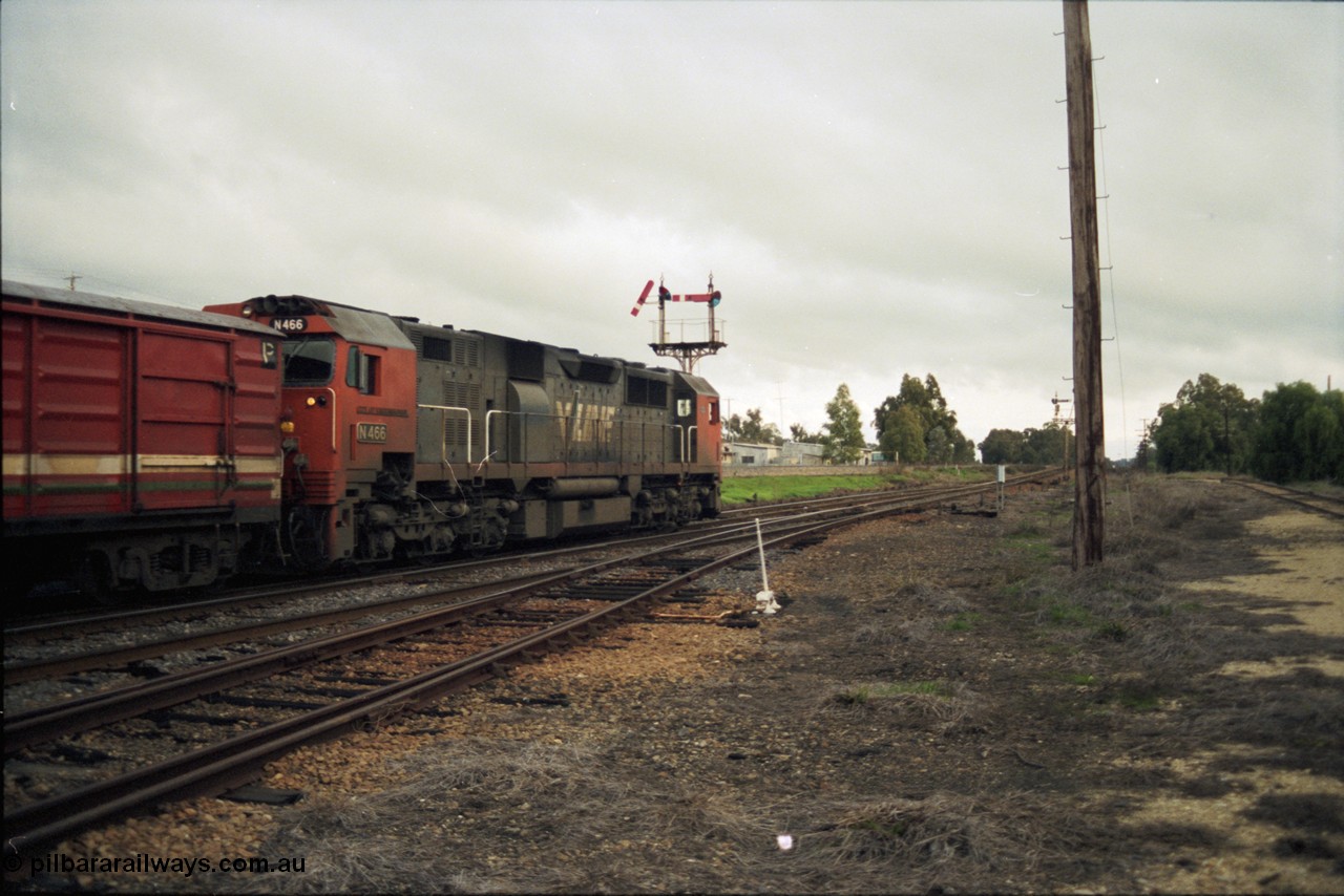 117-12
Springhurst, V/Line N class N 466 'City of Warrnambool' Clyde Engineering EMD model JT22HC-2 serial 86-1195 departs Springhurst with an up Albury passenger train, trailing shot, semaphore signal post 4 pulled off for move, points, point lever, yard view.
Keywords: N-class;N466;Clyde-Engineering-Somerton-Victoria;EMD;JT22HC-2;86-1195;