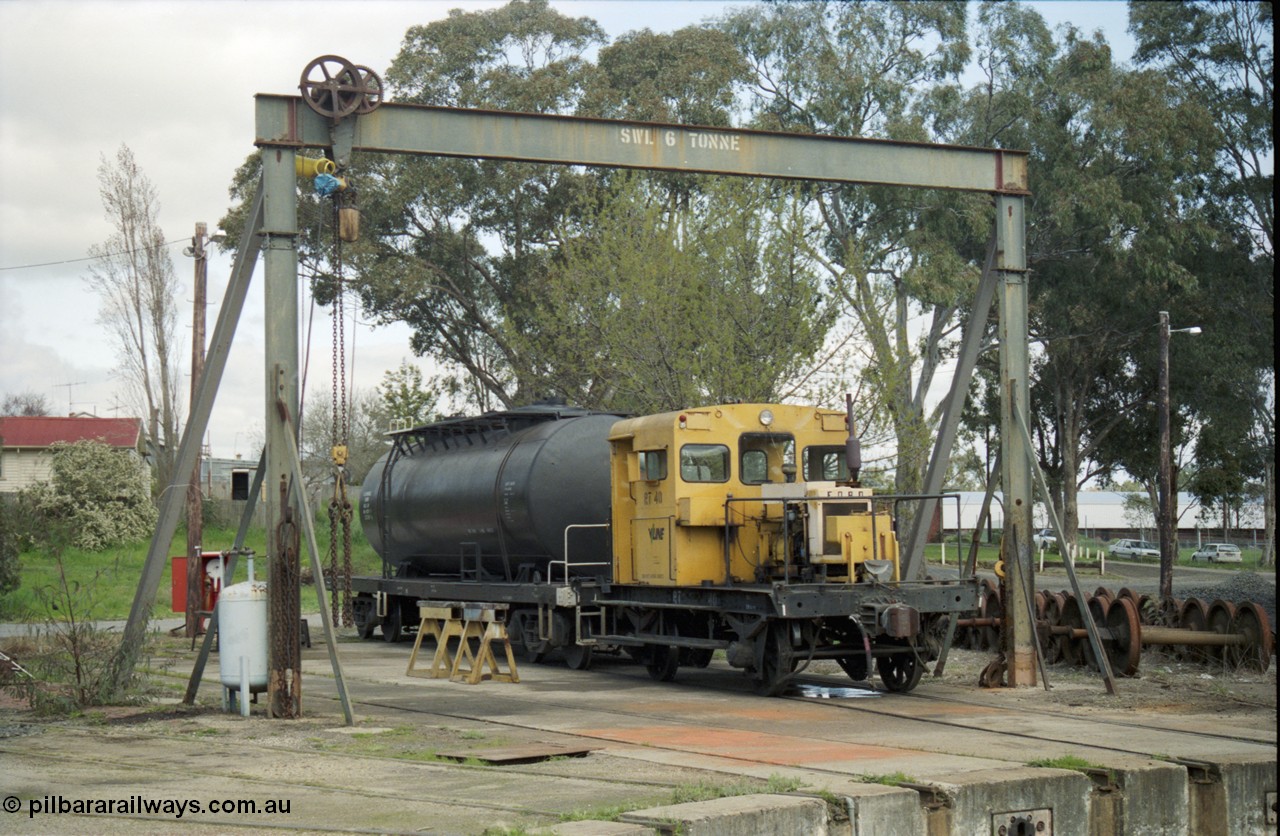 117-33
Seymour loco depot, turntable roads, rail tractor RT class RT 40 Victorian Railways yellow livery with V/Line decal, oil tank bogie waggon, under gantry.
Keywords: RT-class;RT40;