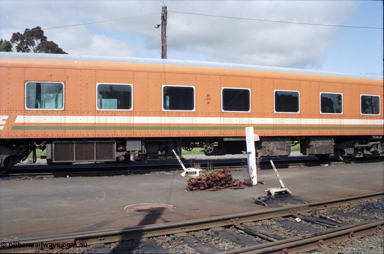 117-37
Seymour loco depot, V/Line BS class bogie passenger coach BS 211, side view. Built in November 1937 at Newport Workshops as broad gauge Sprit of Progress 1st Class coach #3, in August 1939 recoded to AS 3, then in 1983 to BS 11 (2nd) and then August 1984 to BS 211.
Keywords: BS-class;BS211;AS-class;AS3;BS11;