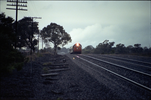 117-01
Somerton, V/Line N class loco N 456 'City of Colac' with serial 85-1224 a Clyde Engineering Somerton Victoria built EMD model JT22HC-2 with up Albury Pass train, standard gauge line on far right, in driving rain.
Keywords: N-class;N456;Clyde-Engineering-Somerton-Victoria;EMD;JT22HC-2;85-1224;