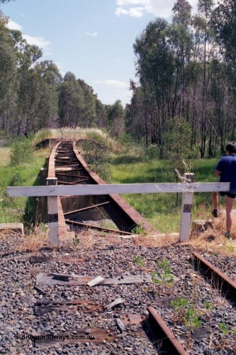 118-13
Tocumwal line, looking south from the 15 km/h speed sign, bridge with deck and rail removed, line disconnected and out of service. [url=https://goo.gl/maps/Tgtv4ysFESAbYFWM8]Geo data[/url].
