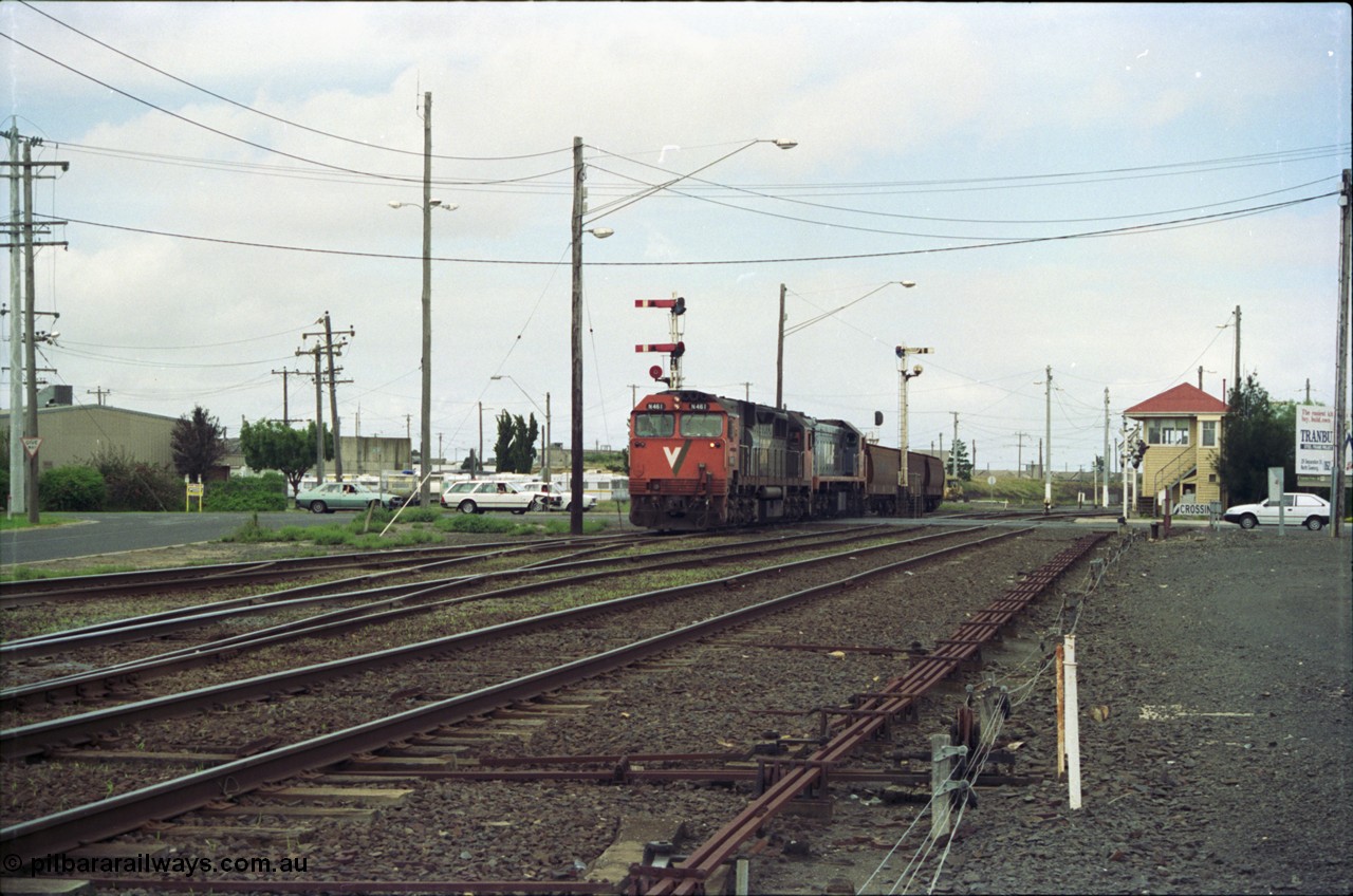 119-00
Nth Geelong C Box, V/Line broad gauge locos N class N 461 'City of Ararat' Clyde Engineering EMD model JT22HC-2 serial 86-1190 and X class X 47 Clyde Engineering EMD model G26C serial 75-794 work an empty grain train onto the mainline to Gheringhap from the Nth Geelong grain loop, crossing Separation Street, semaphore signals, point rodding and signal box.
Keywords: N-class;N461;Clyde-Engineering-Somerton-Victoria;EMD;JT22HC-2;86-1190;