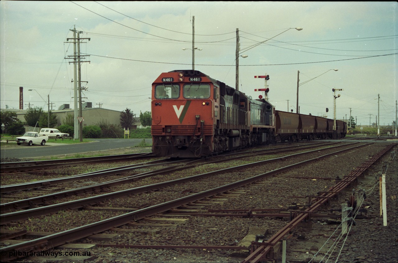 119-01
Nth Geelong C Box, V/Line broad gauge locos N class N 461 'City of Ararat' Clyde Engineering EMD model JT22HC-2 serial 86-1190 and X class X 47 Clyde Engineering EMD model G26C serial 75-794 work an empty grain train onto the mainline to Gheringhap from the Nth Geelong grain loop, crossing Separation Street, semaphore signals, point rodding and signal box.
Keywords: N-class;N461;Clyde-Engineering-Somerton-Victoria;EMD;JT22HC-2;86-1190;