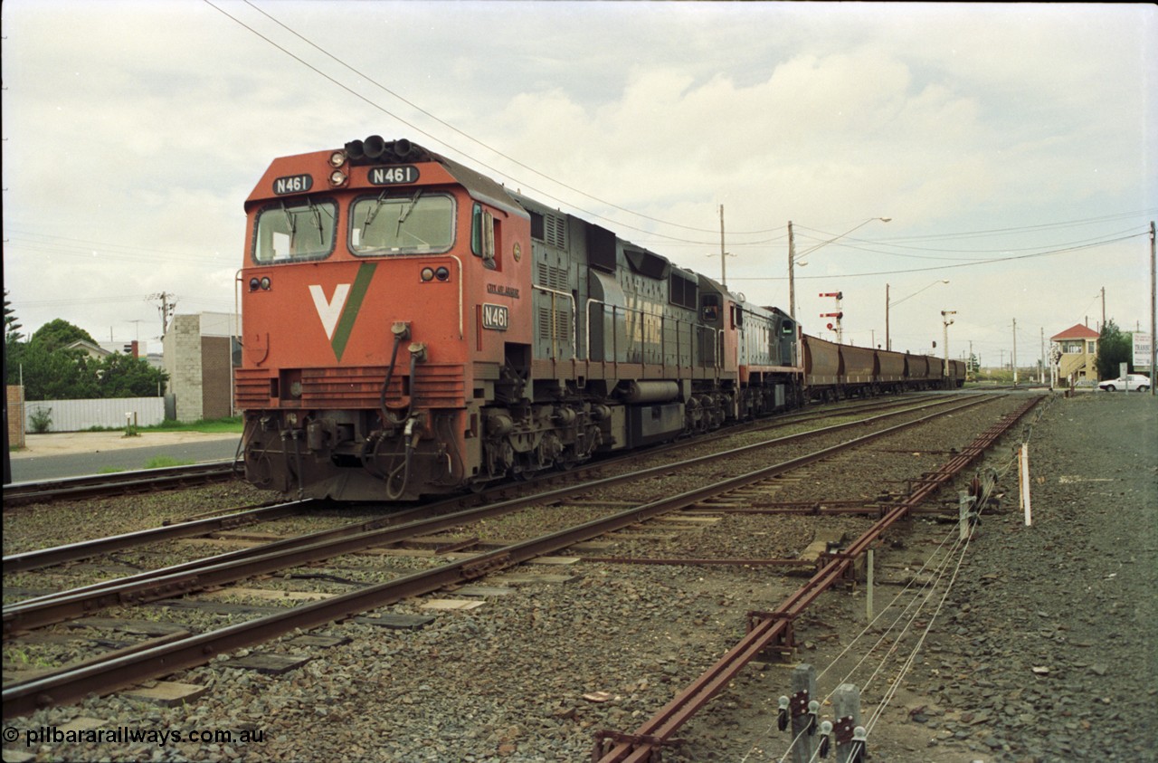 119-02
Nth Geelong C Box, V/Line broad gauge locos N class N 461 'City of Ararat' Clyde Engineering EMD model JT22HC-2 serial 86-1190 and X class X 47 Clyde Engineering EMD model G26C serial 75-794 work an empty grain train onto the mainline to Gheringhap from the Nth Geelong grain loop, crossing Separation Street, semaphore signals, point rodding and signal box.
Keywords: N-class;N461;Clyde-Engineering-Somerton-Victoria;EMD;JT22HC-2;86-1190;