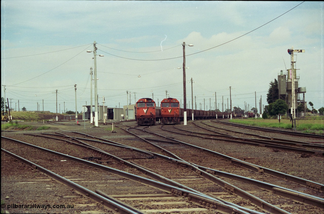 119-03
Nth Geelong yard overview, empty grain trains, V/Line broad gauge N class shunts train back into the Sorting Yard, a G class sits on an empty grain train, looking from Nth Geelong C towards Geelong, grain loop roads and Loop Line at left, semaphore signal post 17 on the right.
Keywords: N-class;N461;Clyde-Engineering-Somerton-Victoria;EMD;JT22HC-2;86-1190;