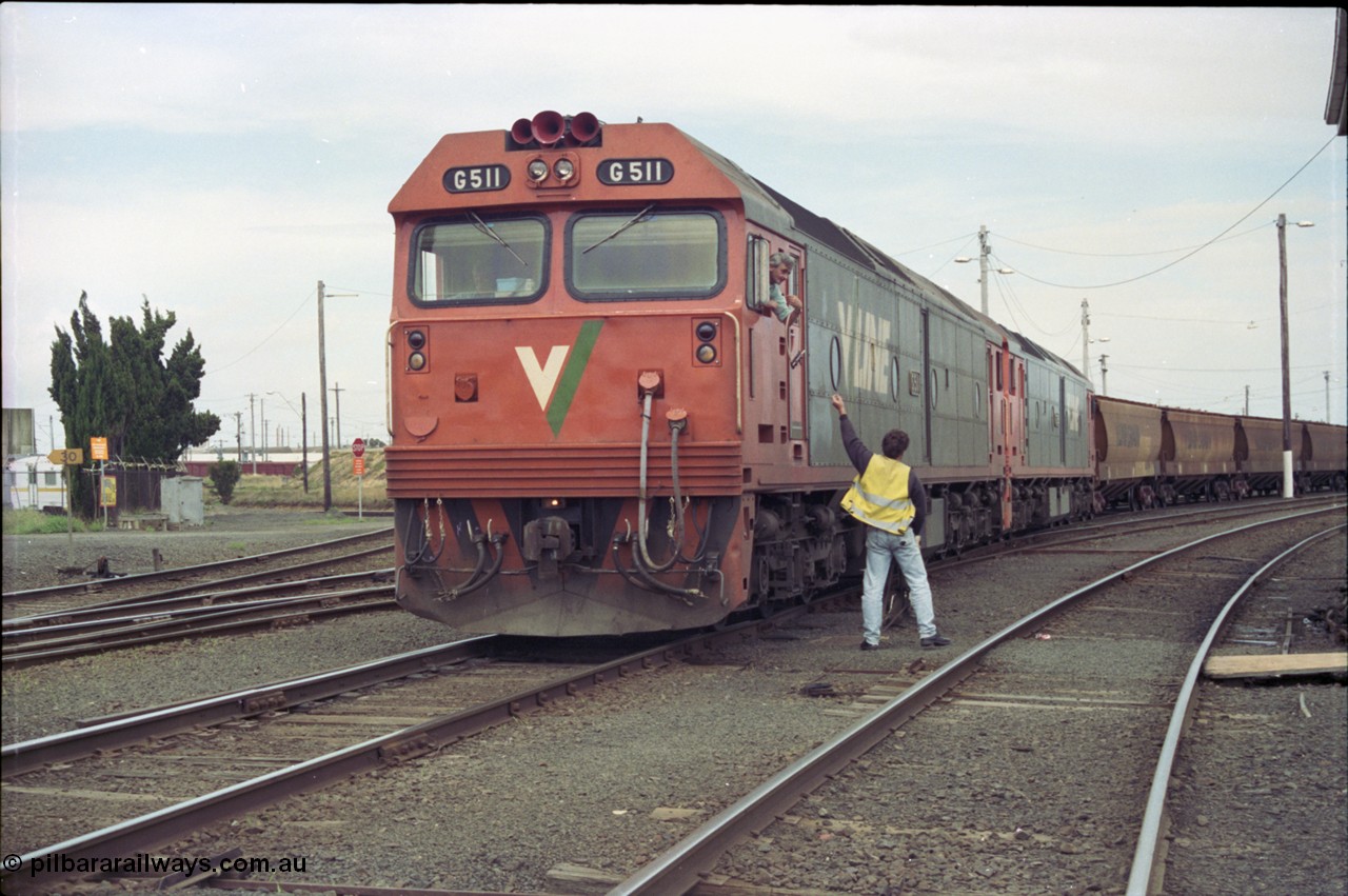 119-05
North Geelong C Box, V/Line broad gauge Series 1 G class leader G 511 Clyde Engineering EMD model JT26C-2SS serial 84-1239 and G 538 Clyde Engineering EMD model JT26C-2SS serial 89-1271 work down empty grain train 9123 as it departs and takes the electric staff for the Gheringhap section off the Nth Geelong C signaller.
Keywords: G-class;G511;Clyde-Engineering-Rosewater-SA;EMD;JT26C-2SS;84-1239;