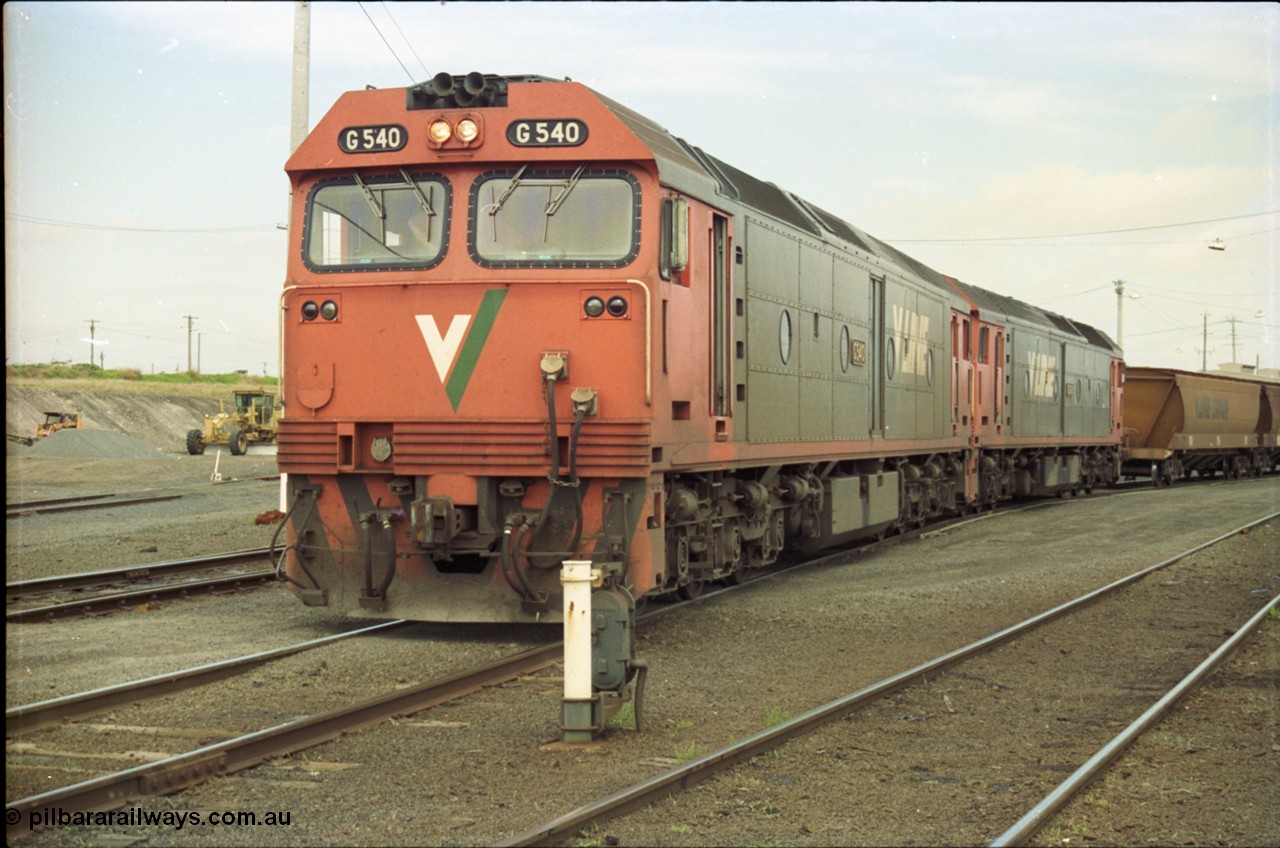 119-09
North Geelong yard, V/Line broad gauge locos G class G 540 Clyde Engineering EMD model JT26C-2SS serial 89-1273 and another G class waiting for shunters to couple up to empty grain rake to form down grain train 9125, ground dwarf signal 20.
Keywords: G-class;G540;Clyde-Engineering-Somerton-Victoria;EMD;JT26C-2SS;89-1273;