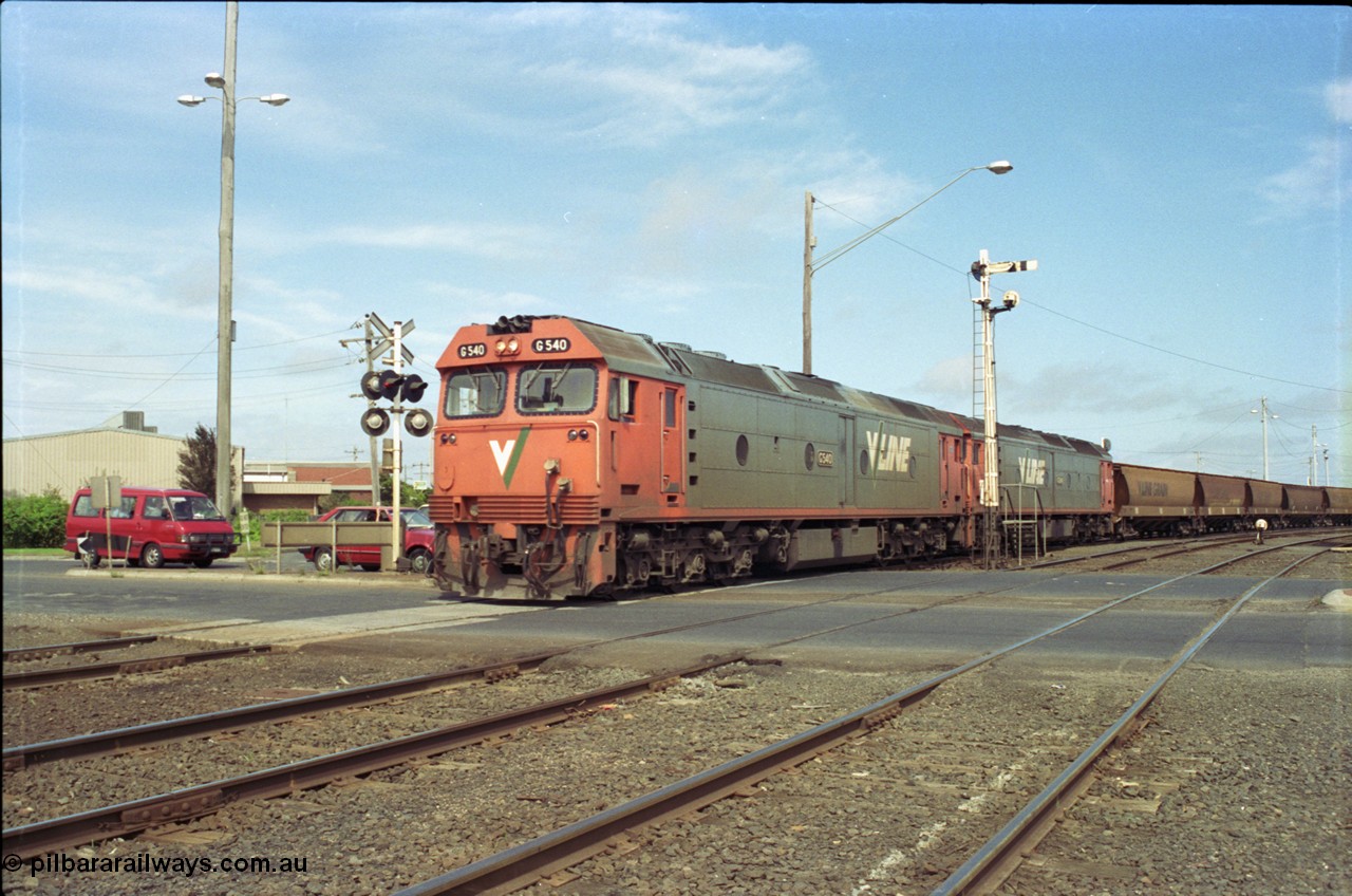 119-12
North Geelong C Box, V/Line broad gauge G class G 540 Clyde Engineering EMD model JT26C-2SS serial 89-1273 and sister depart with down empty grain train 9125, looking across Separation Street, semaphore signal post 16, grade crossing.
Keywords: G-class;G540;Clyde-Engineering-Somerton-Victoria;EMD;JT26C-2SS;89-1273;