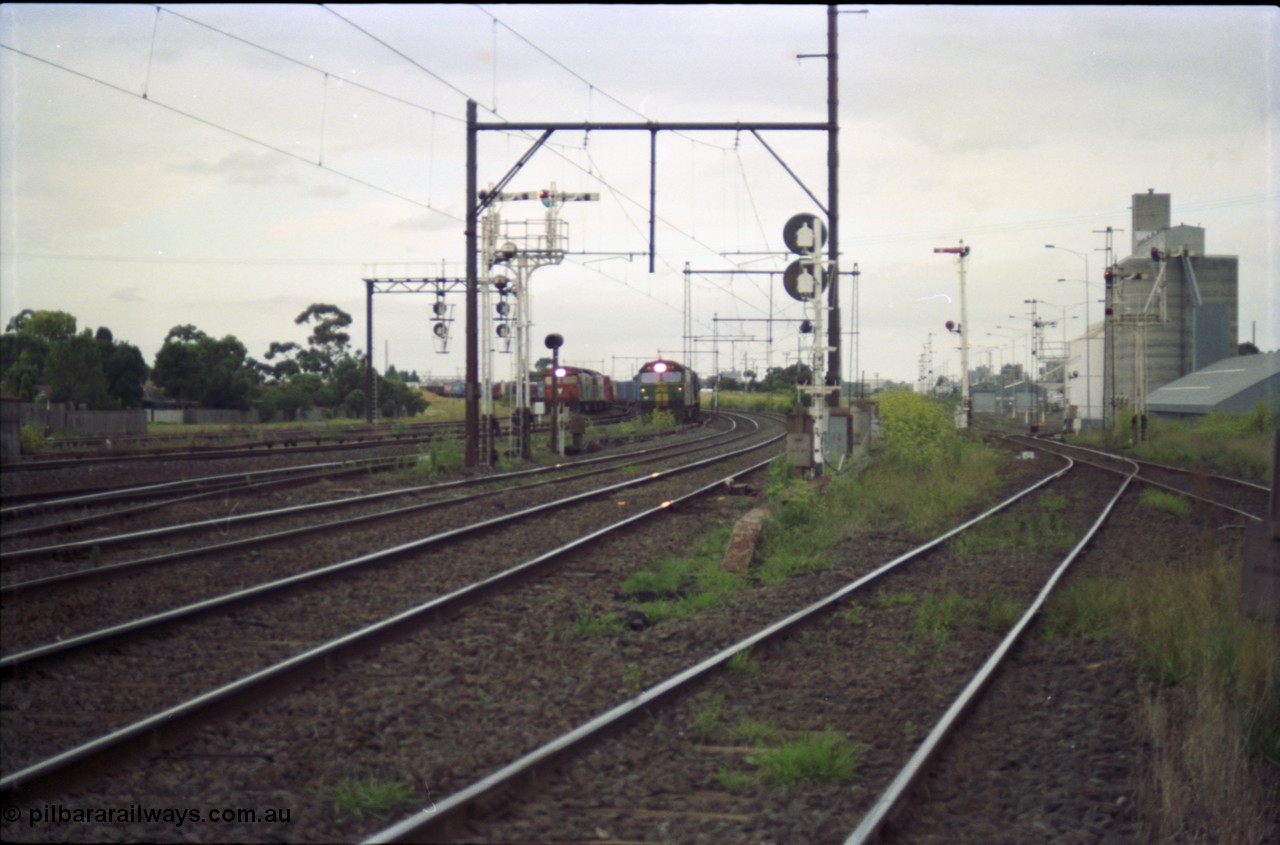 119-15
Sunshine, looking towards Tottenham, broad gauge down goods train 9149 is passed by down standard gauge goods train.
