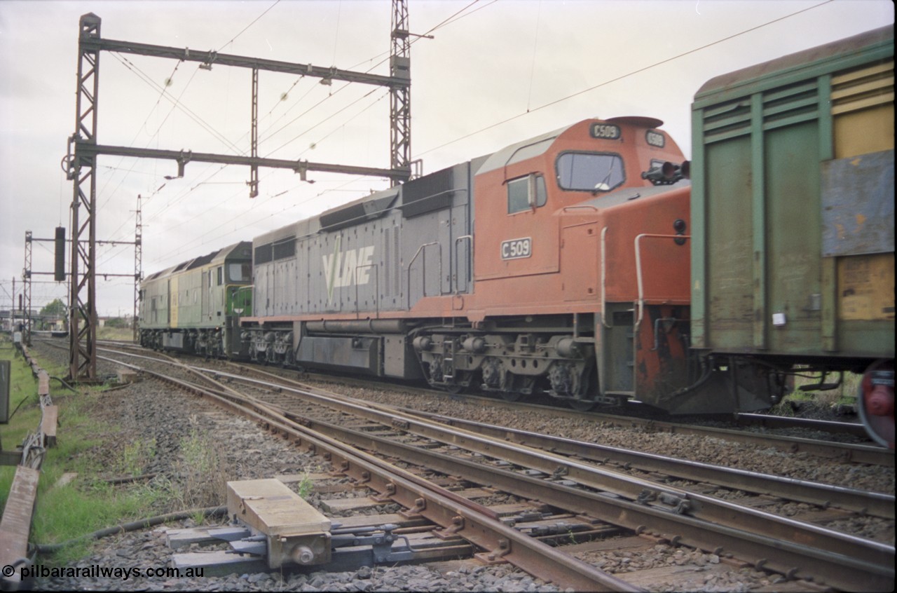 119-20
Sunshine, Australian National broad gauge loco BL class BL 31 Clyde Engineering EMD model JT26C-2SS serial 83-1015 and V/Line C class C 509 Clyde Engineering EMD model GT26C serial 76-832 with down Adelaide goods train 9149, on the Independent Goods Lines, crossing the passenger lines, point machine, trailing view.
Keywords: C-class;C509;Clyde-Engineering-Rosewater-SA;EMD;GT26C;76-832;