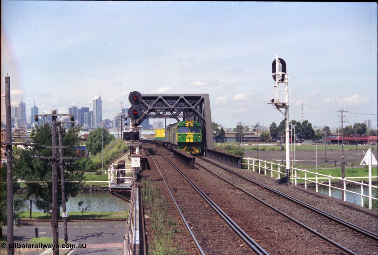 119-21
Maribyrnong River bridge, signal post 162, Australian National broad gauge locos BL class BL 29 Clyde Engineering EMD model JT26C-2SS serial 83-1013 and 700 class 703 AE Goodwin ALCo model DL500G serial G6059-1 working down Adelaide bound goods train 9145 across the river.
Keywords: BL-class;BL29;83-1013;Clyde-Engineering-Rosewater-SA;EMD;JT26C-2SS;