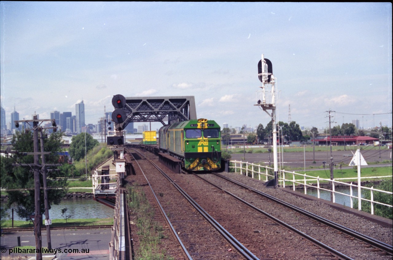 119-22
Maribyrnong River bridge, signal post 162, Australian National broad gauge locos BL class BL 29 Clyde Engineering EMD model JT26C-2SS serial 83-1013 and 700 class 703 AE Goodwin ALCo model DL500G serial G6059-1 working down Adelaide bound goods train 9145 across the river.
Keywords: BL-class;BL29;83-1013;Clyde-Engineering-Rosewater-SA;EMD;JT26C-2SS;
