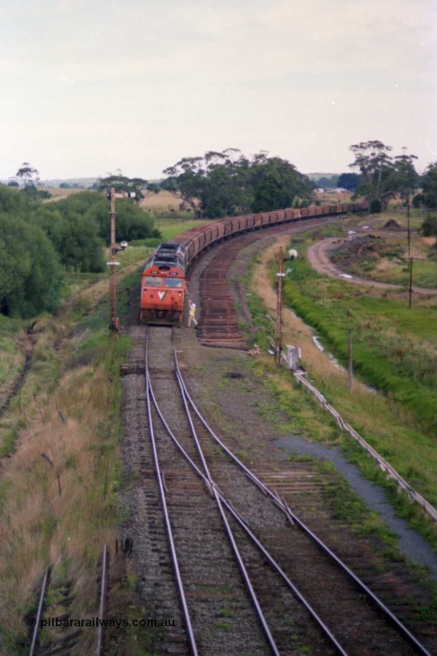 119-34
Warrenheip, V/Line broad gauge G class locos G 513 Clyde Engineering EMD model JT26C-2SS serial 85-1241 with another G class working down empty grain train 9125, swaps the electric staff for a caution order with the signaller, remains of removed Siding C on the right, semaphore signal post 2 and disc signal post 3.
Keywords: G-class;G513;Clyde-Engineering-Rosewater-SA;EMD;JT26C-2SS;85-1241;