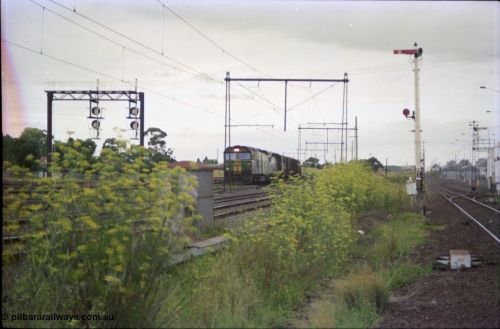 119-17
Sunshine, Australian National broad gauge loco BL class BL 31 Clyde Engineering EMD model JT26C-2SS serial 83-1015 and V/Line C class C 509 Clyde Engineering EMD model GT26C serial 76-832 with down Adelaide goods train 9149, on the Independent Goods Lines, about to cross passenger lines, Brooklyn loop line with semaphore signal post 49 at right, signal gantry is for the now removed Sunshine standard gauge loop.
Keywords: BL-class;BL31;Clyde-Engineering-Rosewater-SA;EMD;JT26C-2SS;83-1015;