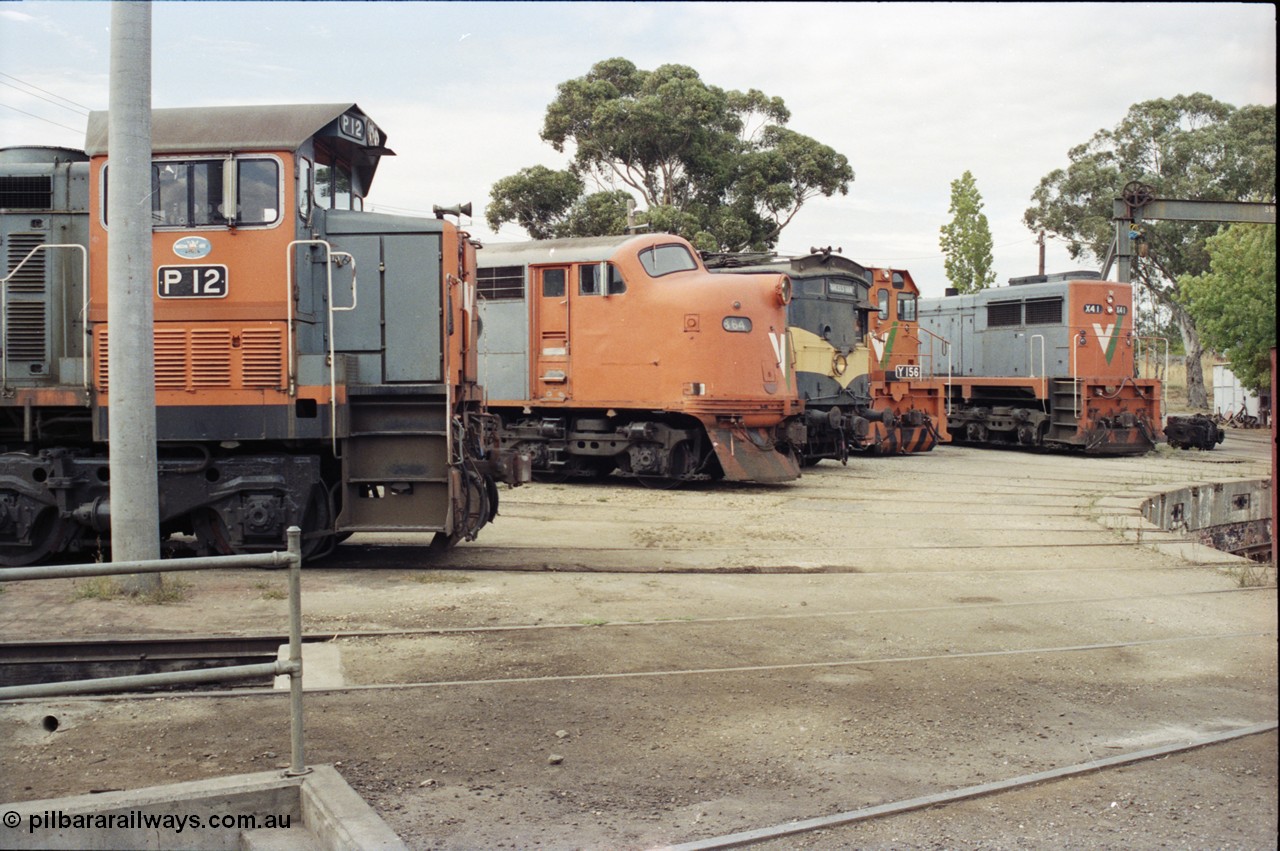 120-12
Seymour loco depot, turntable and pit, V/Line broad gauge locos, P class P 12 Clyde Engineering EMD model G18HBR serial 84-1206 rebuilt from T 329 Clyde Engineering EMD model G8B serial 56-82, B class B 64 Clyde Engineering EMD model ML2 serial ML2-5, CM class CM 3 parcels van, Y class Y 156 Clyde Engineering EMD model G6B serial 67-576 and X class X 41 Clyde Engineering EMD model G26C serial 70-704.
Keywords: P-class;P12;84-1206;Clyde-Engineering-Somerton-Victoria;EMD;G18HBR;