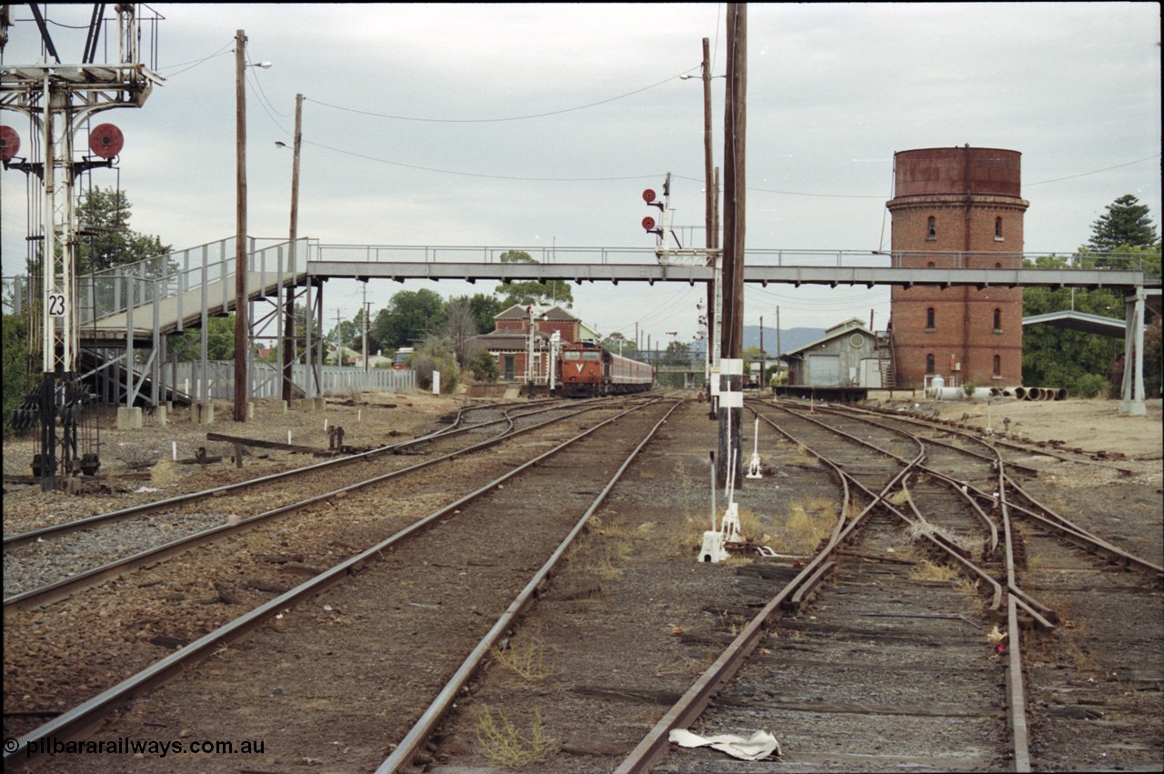 120-25
Wangaratta station yard overview, V/Line broad gauge loco N class N 474 'City of Traralgon' Clyde Engineering EMD model JT22HC-2 serial 87-1203 with down Albury passenger train at platform, footbridge, track work, goods shed and water tower, double compound points and levers.
Keywords: N-class;N474;Clyde-Engineering-Somerton-Victoria;EMD;JT22HC-2;87-1203;