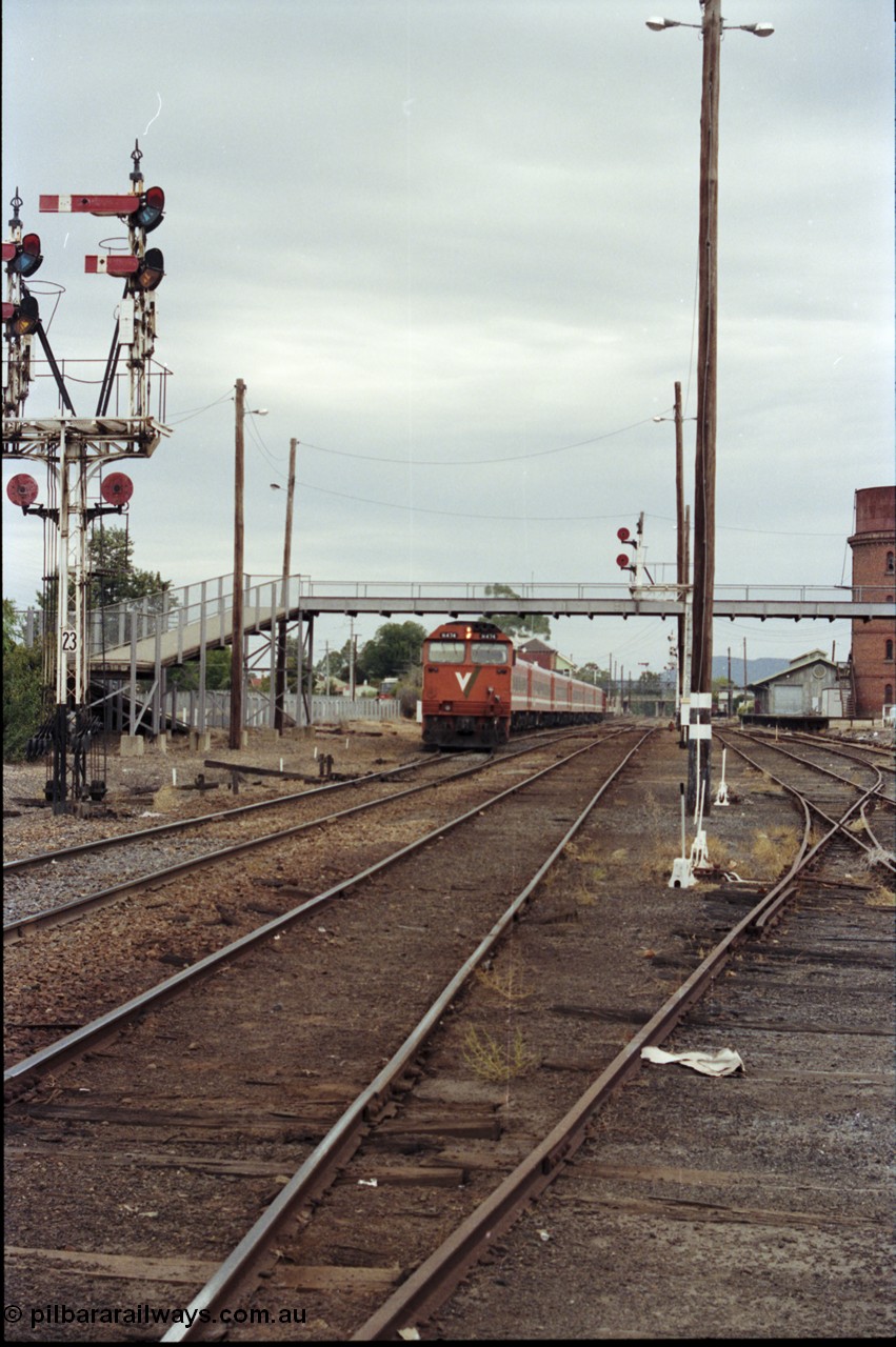 120-26
Wangaratta station yard overview, V/Line broad gauge loco N class N 474 'City of Traralgon' Clyde Engineering EMD model JT22HC-2 serial 87-1203 with down Albury passenger train departing, footbridge, track work, goods shed, point levers, part of semaphore signal post 23.
Keywords: N-class;N474;Clyde-Engineering-Somerton-Victoria;EMD;JT22HC-2;87-1203;