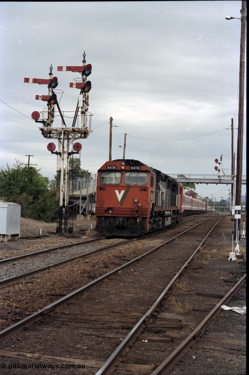 120-27
Wangaratta station yard view, V/Line broad gauge loco N class N 474 'City of Traralgon' Clyde Engineering EMD model JT22HC-2 serial 87-1203 with down Albury passenger train departing past still fully intact and interlocked semaphore signal post 23, footbridge.
Keywords: N-class;N474;Clyde-Engineering-Somerton-Victoria;EMD;JT22HC-2;87-1203;