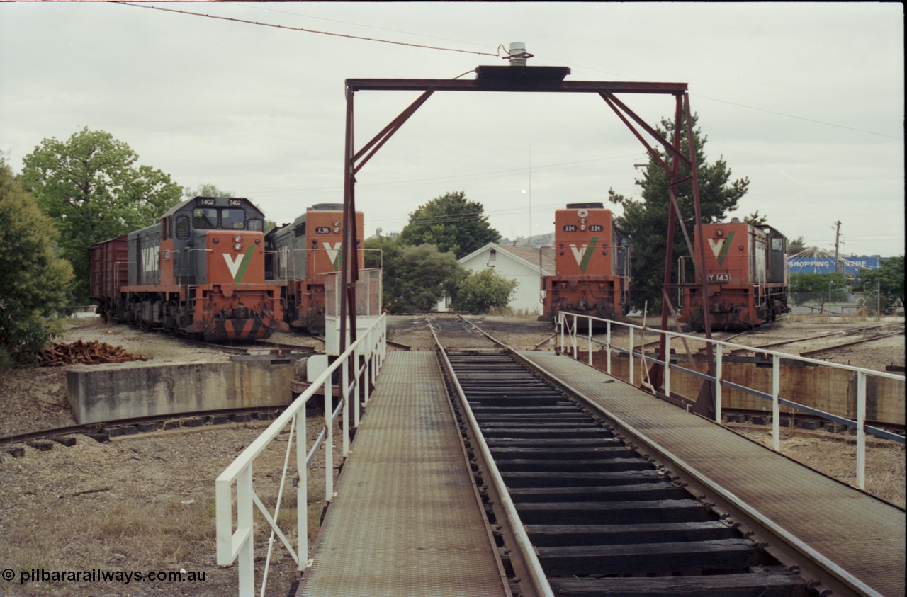 120-31
Wodonga loco depot turntable, pit and deck, looking across deck at radial roads sees V/Line broad gauge locos from left, T class T 402 Clyde Engineering EMD model G18B serial 67-497, X class X 36 Clyde Engineering EMD model G16C serial 66-489, X class X 54 Clyde Engineering EMD model G26C serial 75-801, Y class Y 143 Clyde Engineering EMD model G6B serial 65-409.
Keywords: T-class;T402;Clyde-Engineering-Granville-NSW;EMD;G18B;67-497;