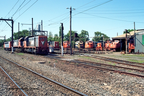 122-06
Traralgon loco depot overview, turntable and roundhouse, V/Line broad gauge loco classes present are all Clyde Engineering EMD models: T class G8B and G18B. X class G26C. A class AAT22C-2R rebuilt from ML2. B class ML2. Y class G6B. G class JT26C-2SS and S class A7. March 1992.
