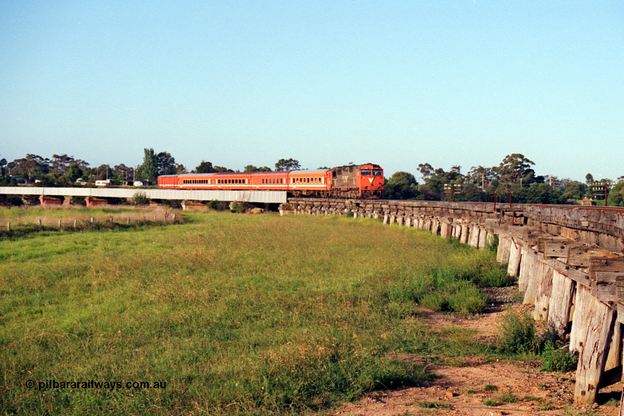 123-1-16
Avon River steel bridge, trestle bridge over flood plain at right, V/Line broad gauge N class N 451 'City of Portland' Clyde Engineering EMD model JT22HC-2 serial 85-1219 N set, up Bairnsdale pass.
Keywords: N-class;N451;Clyde-Engineering-Somerton-Victoria;EMD;JT22HC-2;85-1219;