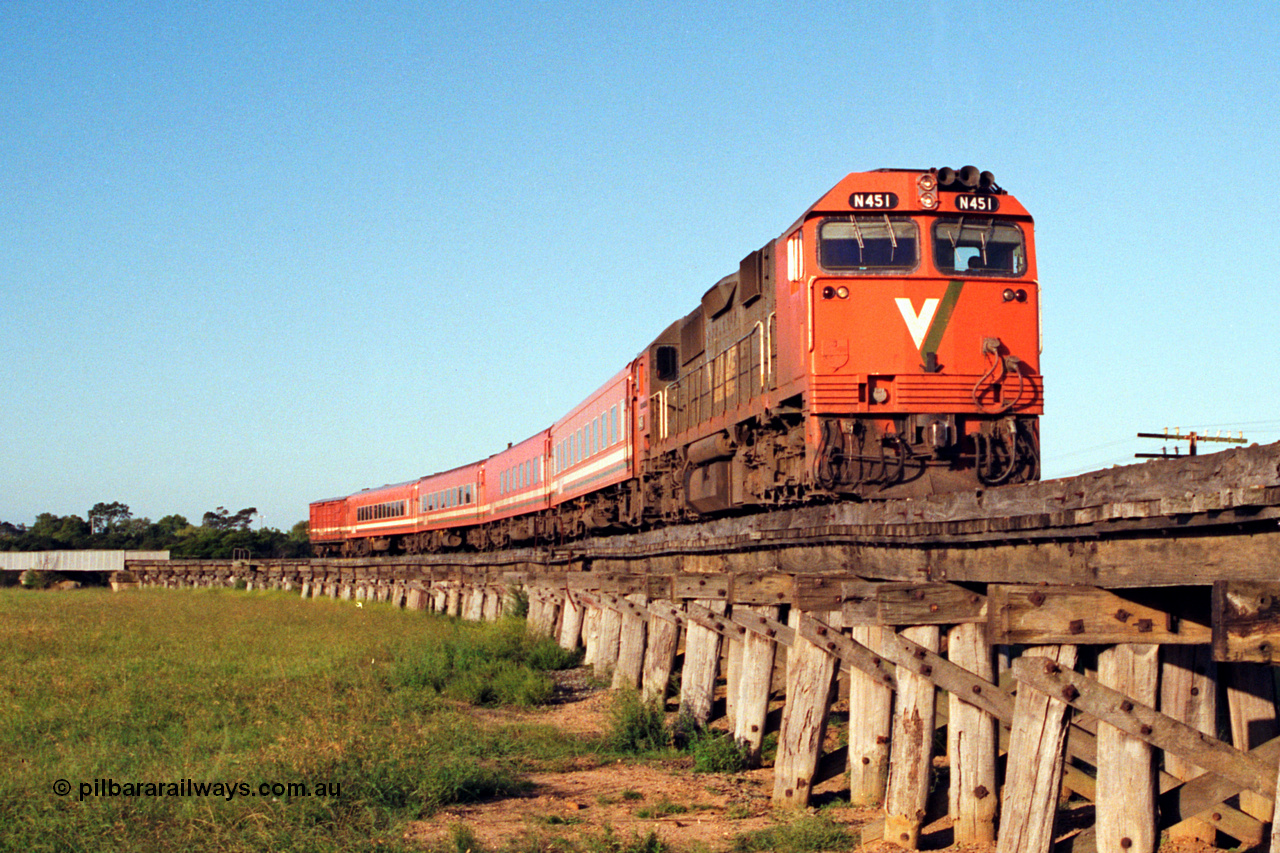 123-1-19
Avon River steel bridge at left, trestle bridge over flood plain, V/Line broad gauge N class N 451 'City of Portland' Clyde Engineering EMD model JT22HC-2 serial 85-1219, N set, up Bairnsdale pass.
Keywords: N-class;N451;Clyde-Engineering-Somerton-Victoria;EMD;JT22HC-2;85-1219;