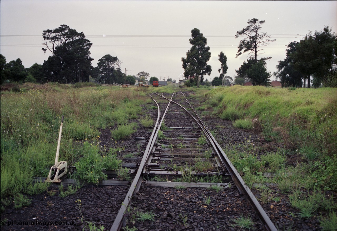 123-2-05
Maffra station yard overview, looking from Tinamba, points and lever, rail tractor in the background, station building further on, factories on the right.
