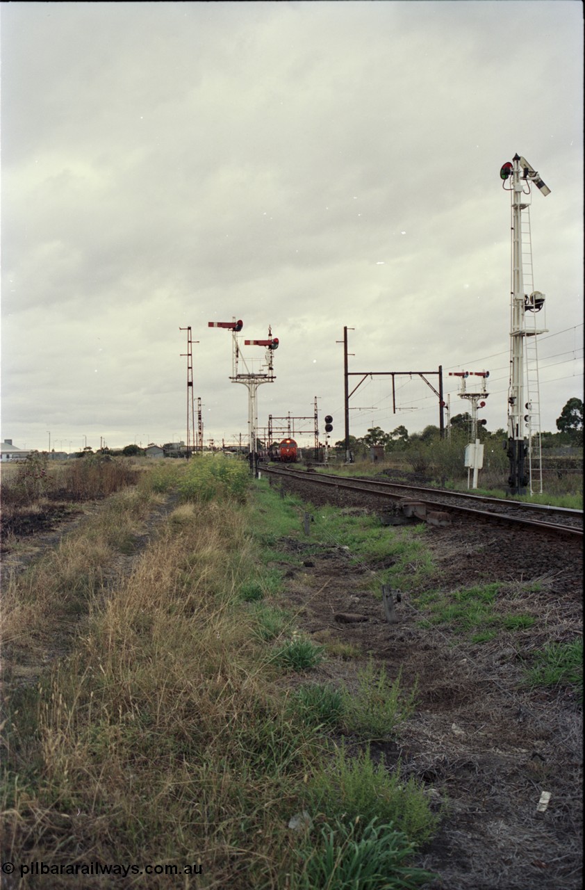 123-2-20
Sunshine track view, Newport - Sunshine Loop Line, looking towards Sunshine, double doll semaphore signal posts 36 and pulled off semaphore signal post 49, G class arriving with an up Brooklyn bound Apex quarry train.
