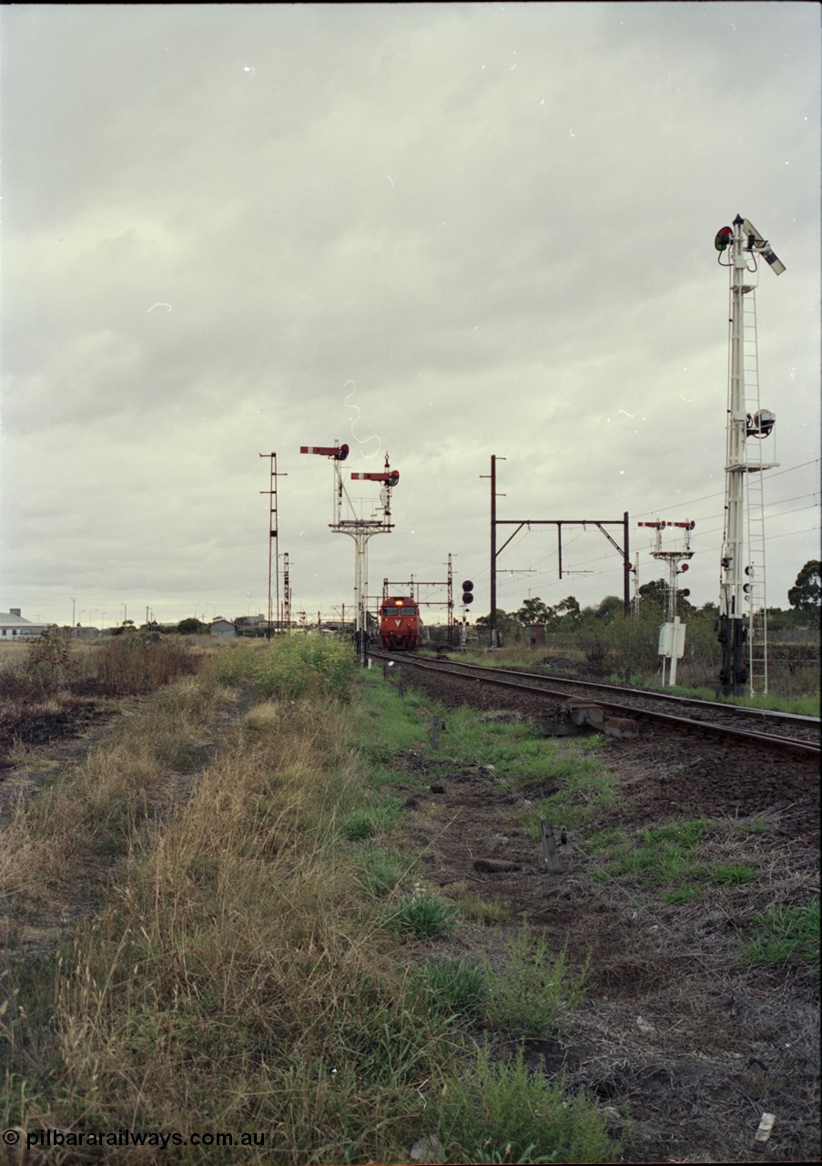 123-2-21
Sunshine track view, Newport - Sunshine Loop Line, looking towards Sunshine, double doll semaphore signal posts 36 and pulled off semaphore signal post 49, G class arriving with an up Brooklyn bound Apex quarry train.
