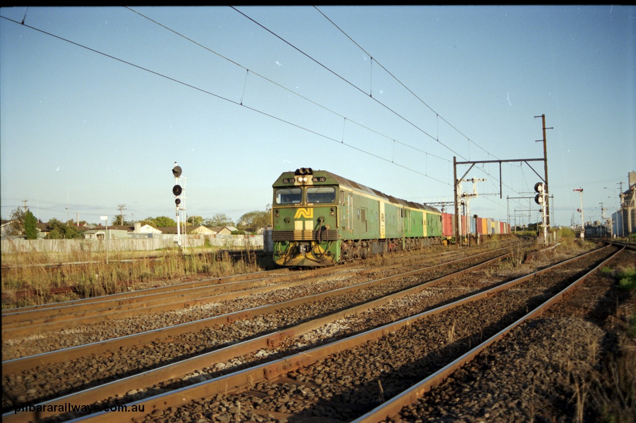 124-19
Sunshine broad gauge Australian National BL classes Clyde Engineering EMD model JT26C-2SS serial 83-1014 and BL 35 Clyde Engineering EMD model JT26C-2SS serial 83-1019 with a down Adelaide bound goods train head off the Independent Through Goods line and cross over the passenger lines heading for the main western line.
Keywords: BL-class;BL30;Clyde-Engineering-Rosewater-SA;EMD;JT26C-2SS;83-1014;