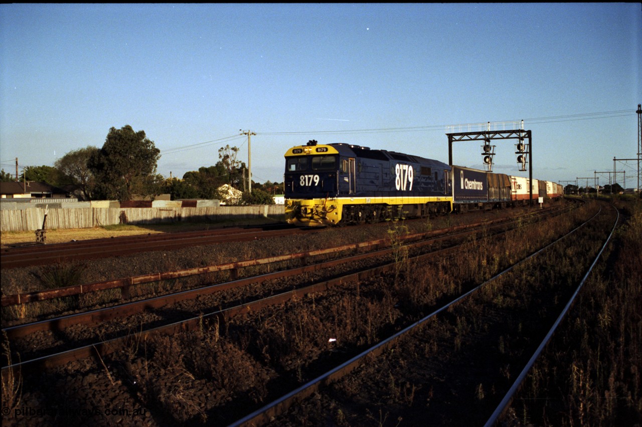 124-22
Sunshine Loop, standard gauge NSWSRA 81 class 8179 Clyde Engineering EMD model JT26C-2SS serial 85-1098 in new Freight Rail Stealth livery with a down goods train passing under the searchlight signal gantry, the two lines in the foreground are the broad gauge Independent Through Goods Lines
Keywords: 81-class;8179;Clyde-Engineering-Kelso-NSW;EMD;JT26C-2SS;85-1098;