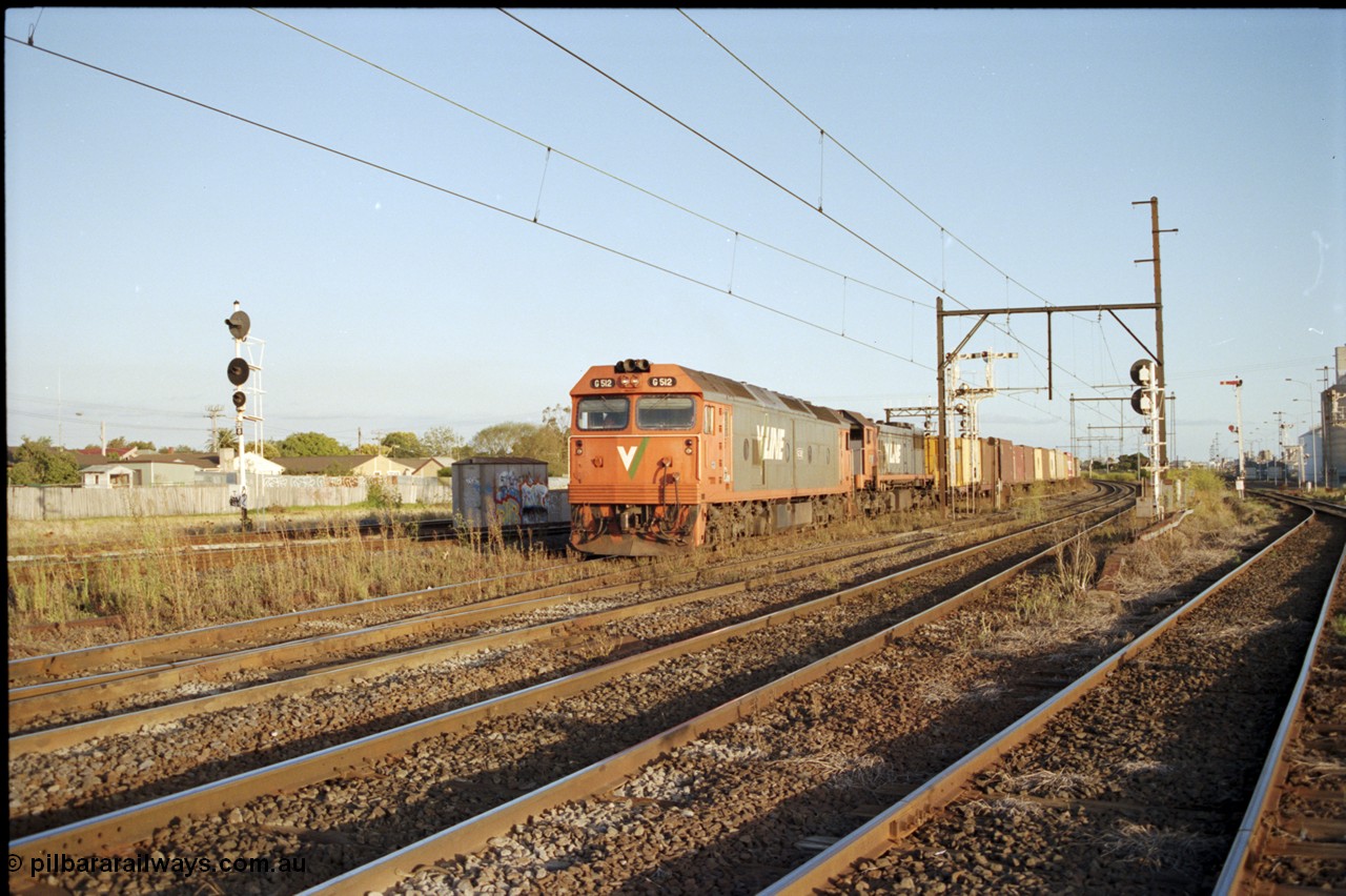 124-24
Sunshine V/Line down broad gauge Adelaide goods train with G class G 512 Clyde Engineering EMD model JT26C-2SS serial 84-1240 and X class X 51 Clyde Engineering EMD model G26C serial 75-798, train about to cross over passenger lines, signal post 31 back at stop on Independent Through Goods Line, up home searchlight signal post for the standard gauge Sunshine Loop on the left, Newport - Sunshine Loop Line at far right
Keywords: G-class;G512;Clyde-Engineering-Rosewater-SA;EMD;JT26C-2SS;84-1240;