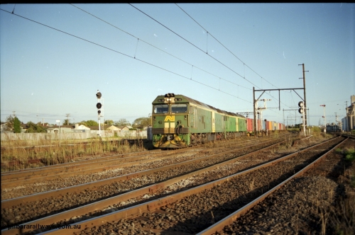 124-19
Sunshine broad gauge Australian National BL classes Clyde Engineering EMD model JT26C-2SS serial 83-1014 and BL 35 Clyde Engineering EMD model JT26C-2SS serial 83-1019 with a down Adelaide bound goods train head off the Independent Through Goods line and cross over the passenger lines heading for the main western line.
Keywords: BL-class;BL30;Clyde-Engineering-Rosewater-SA;EMD;JT26C-2SS;83-1014;