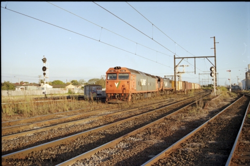 124-24
Sunshine V/Line down broad gauge Adelaide goods train with G class G 512 Clyde Engineering EMD model JT26C-2SS serial 84-1240 and X class X 51 Clyde Engineering EMD model G26C serial 75-798, train about to cross over passenger lines, signal post 31 back at stop on Independent Through Goods Line, up home searchlight signal post for the standard gauge Sunshine Loop on the left, Newport - Sunshine Loop Line at far right
Keywords: G-class;G512;Clyde-Engineering-Rosewater-SA;EMD;JT26C-2SS;84-1240;