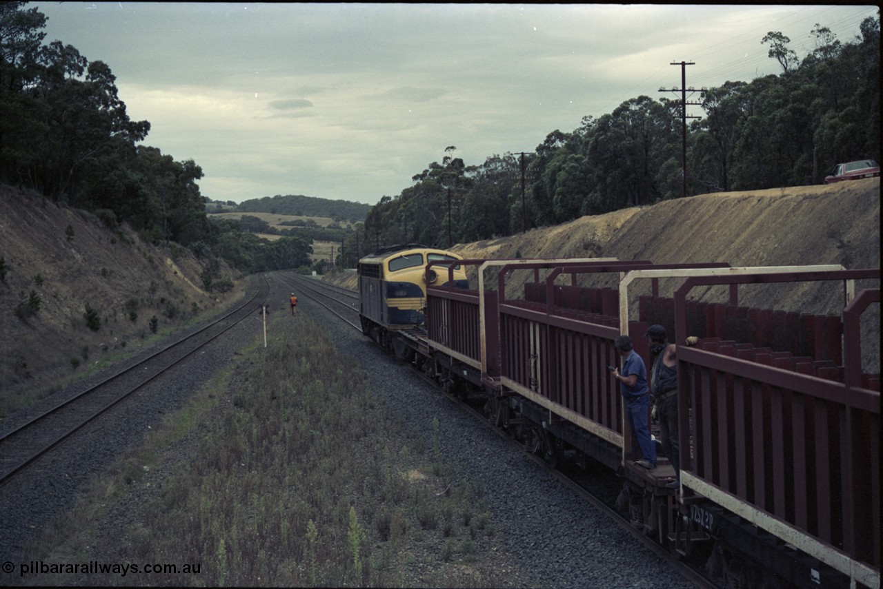 125-22
Heathcote Junction, V/Line broad gauge B class Clyde Engineering EMD model ML2 serial ML2-6 still in Victorian Railways livery leads a sleeper discharge train on the up broad gauge line, rolling down toward Wallan, gangers on waggon, V/Line VZSX class waggons.
Keywords: B-class;B65;Clyde-Engineering-Granville-NSW;EMD;ML2;ML2-6;bulldog;