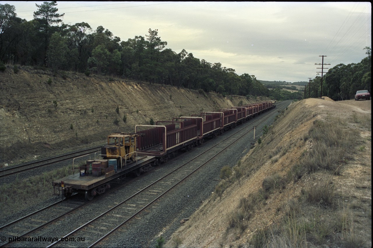 125-23
Heathcote Junction, V/Line broad gauge B class Clyde Engineering EMD model ML2 serial ML2-6 still in Victorian Railways livery leads a sleeper discharge train on the up broad gauge line, rolling down towards Wallan, trailing shot, V/Line VZSX class bogie sleeper waggons, train half empty, sleeper discharge machine.
