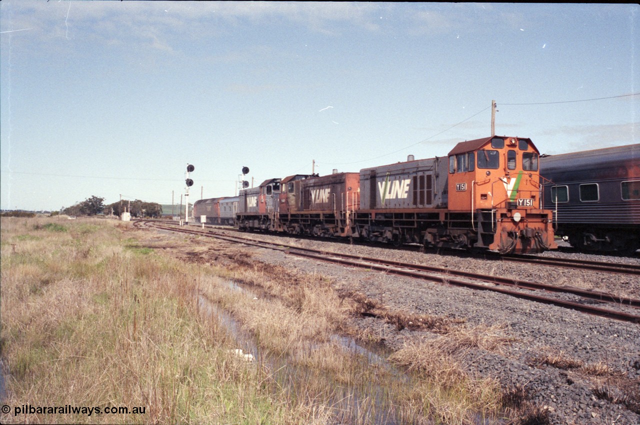 126-27
Wallan Loop, standard gauge V/Line G class G 518 Clyde Engineering EMD model JT26C-2SS serial 85-1231 runs the Up Melbourne Express passenger train, crossing relief light locos in loop at Wallan, V/Line Clyde Engineering EMD G8B model Y classes Y 151 serial 67-571 and Y 102 serial 63-292 and G18B T class T 411 serial 68-627.
Keywords: Y-class;Y151;Clyde-Engineering-Granville-NSW;EMD;G6B;67-571;