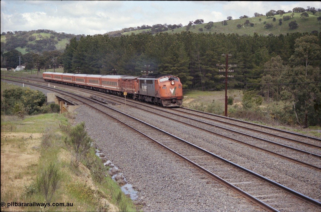 126-34
Kilmore East, Sunday Creek Rd overbridge, V/Line A class A 70 Clyde Engineering EMD model AAT22C-2R serial 84-1187 rebuilt from B 70 Clyde Engineering EMD model ML2 serial ML2-11 and N set, down broad gauge Albury pass.
Keywords: A-class;A70;Clyde-Engineering-Rosewater-SA;EMD;AAT22C-2R;84-1187;rebuild;bulldog;